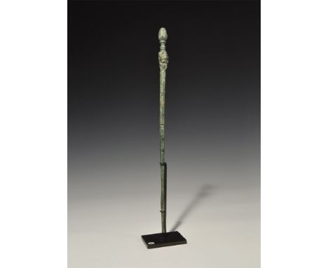 1st century BC-1st century AD. A tapering round-section dress pin with ribbed surface, finial formed as a gryphon's head with