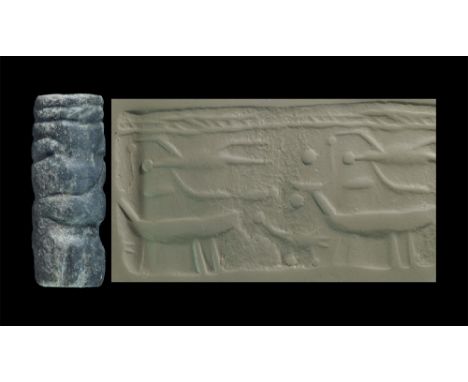 Circa 3000 BC. A hardstone cylinder seal with man, ox and bird group, accompanied by a museum-quality impression and a copy o