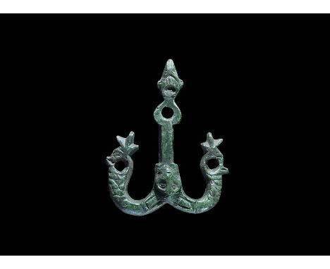 9th-10th century AD. A bronze belt mount with vertical bar and two hooks; the bar with trefoil finial and pierced lobe, mask 