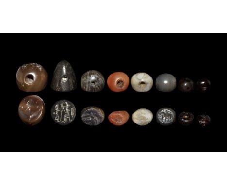 3rd-7th century AD. A mixed group of agate and carnelian stamp seals comprising: one conical with intaglio seated figure faci