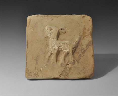 8th-12th century AD. A square terracotta tile with low-relief image of a goat with head and tail raised. 1.3 kg, 19.5cm (7 3/