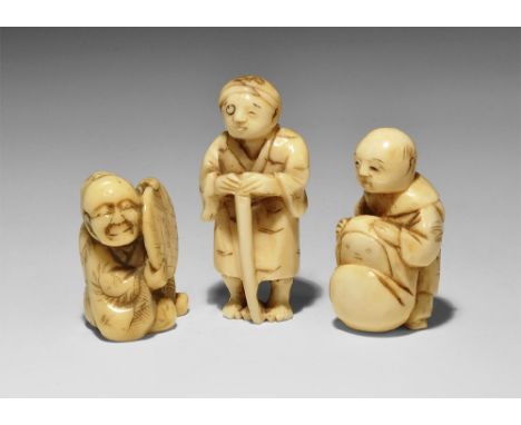 Late 19th-very early 20th century AD. A mixed group of carved ivory netsuke figurines comprising: a standing robed figure hol