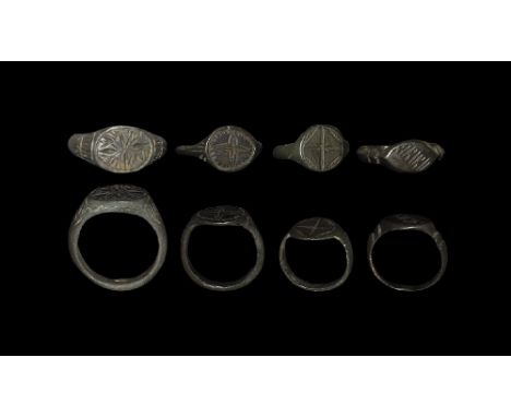 13th-15th century AD. A group of bronze rings comprising: three rings with engraved cross/star decoration, one with vesica sh
