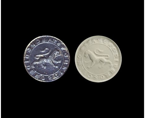 13th-14th century AD. A Italian bronze circular flat seal with raised rib and suspension loop to reverse with intaglio design