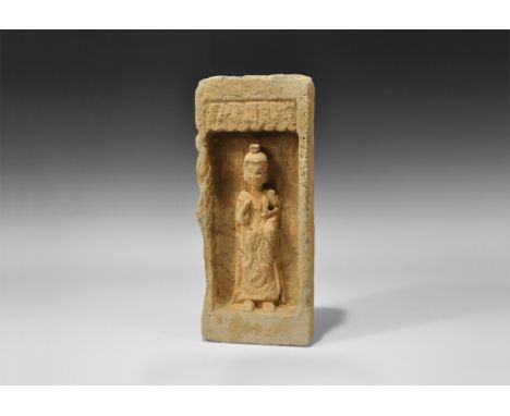 Northern Wei Dynasty, 386-534 AD. A rectangular terracotta brick with recess to the upper face enclosing a robed Buddha figur