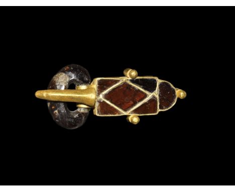 Early 5th century AD. A buckle assemblage comprising: a gold tongue-shaped plaque with one lozengiform and four triangular ga