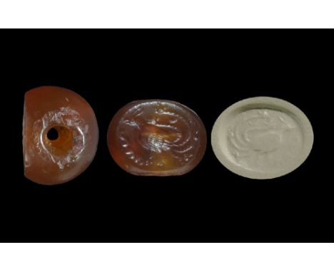 3rd-7th century AD. A carved agate seal matrix with intaglio design of a long-tailed bird with Pahlavi text below; supplied w