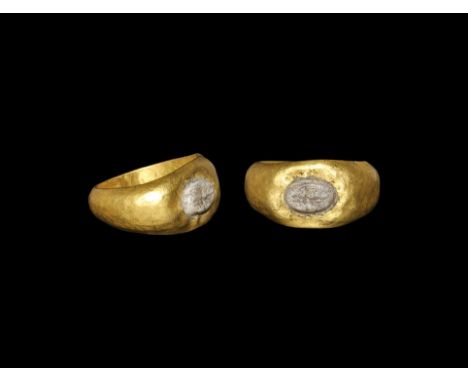 1st-3rd century AD. A gold ring with wide shank tapering to the middle, top slightly flattened and recessed with an intaglio 
