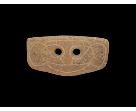 4th-3rd century BC. A rectangular slightly curved ceramic mask with two eye-holes and incised stylised facial details; pierce