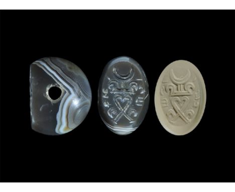 3rd-7th century AD. A carved banded agate seal matrix with intaglio design of a battle standard with text around; supplied wi