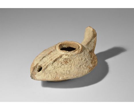 1st century BC-1st century AD. A small terracotta slipper-shaped oil lamp with floral and grapevines decoration to the should