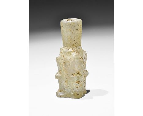 9th-11th century AD. A miniature pale green glass molar flask with segmented body and funicular hexagonal-section neck, four 