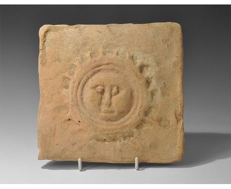 8th-12th century AD. A square terracotta tile with low-relief image of Helios portrayed as a male mask within a radiating bor