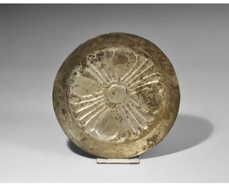 3rd century BC. A squat silver bowl with flared carinated rim, repoussé design of a quatrefoil with ovoid plaques. 128 grams,