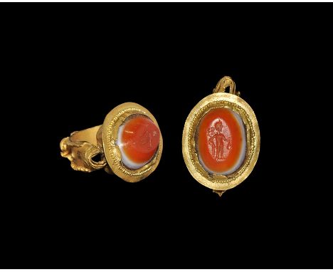2nd century AD. A broad flat-section gold hoop with granules to the outer edges, median rosette, hinged plaque with beaded bo