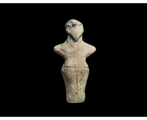 Neolithic, 6th-5th millennium BC. A terracotta robed figure with stub arms, pinched facial features, possible beard; incised 