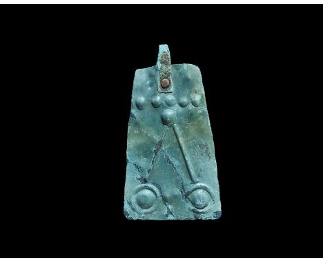 10th-12th century AD. A flat-section trapezoidal bronze plaque with repoussé design of a line of five bosses and two bosses i