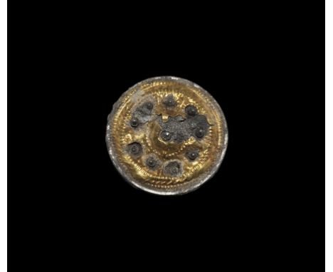 14th-16th century AD. A silver plaque with applied gold domed sheet with repoussé ropework detailing, ring of silver points p