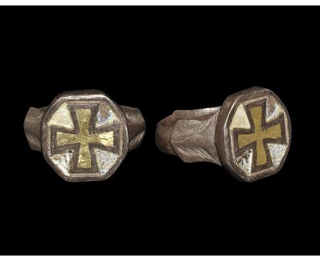 Early 12th-early 14th century AD. A silver ring with shield-shaped flanges to the shank and a hexagonal bezel with inlaid sil