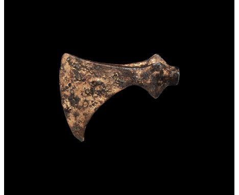 10th-12th century AD. A hand-forged iron axehead with broad expanding blade and gently curved edge, socket with lateral flang