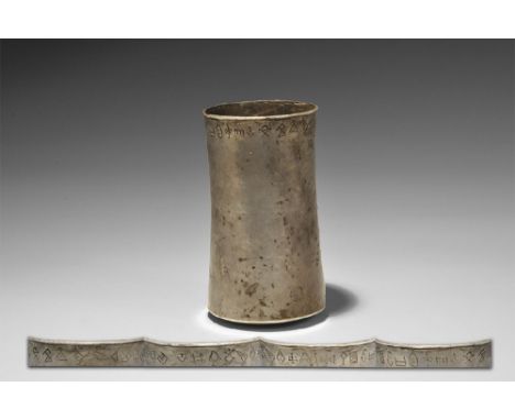 3rd millennium BC. A sheet silver vessel with domed plaque to the base, waisted profile, everted rim, band of Proto-Elamite t