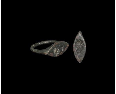 3rd-1st century BC. A D-section keeled hoop supporting a scaphoid plaque with intaglio profile bust of a clean-shaven youthfu