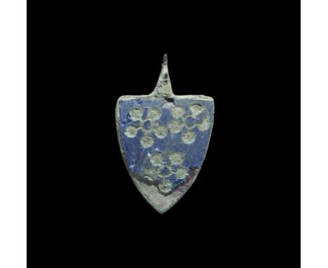 13th century AD. A bronze heater-shaped pendant with pierced lug suspension; enamelled face with three reserved flowers blazo