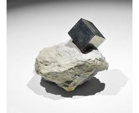 . A superbly formed pyrite cube (Fool's Gold) on matrix; in old white card tray with Gregory, Bottley & Lloyd identification 
