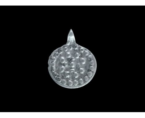 10th-12th century AD. A silver discoid plaque with integral pierced lug, concentric rings of pellets. 6.68 grams, 34mm (1 1/2