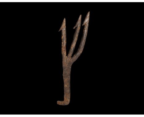9th-12th century AD. A hand-forged iron trident comprising a square-section shank with right-angled attachment lug, three ver