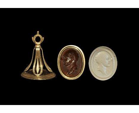 19th century AD. A gold mounted fob seal with openwork frame and oval bloodstone face depicting an intaglio bearded male (a p