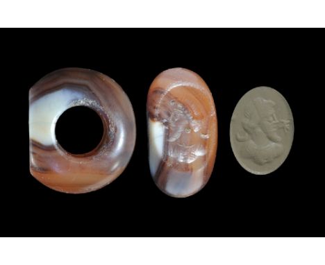 3rd-7th century AD. A carved carnelian seal matrix with intaglio bearded male bust, flanked by a crescent moon and a star; su