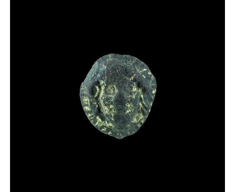 13th-15th century AD. A gilt bronze discoid mount with pelleted border and a central motif of a youthful face. 6 grams, 26mm 