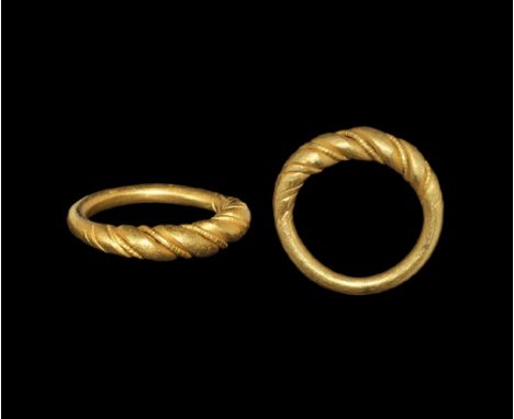 9th-11th century AD. A round-section hoop with expanding shoulders and plaque ornamented with faux-twist detailing, narrow no