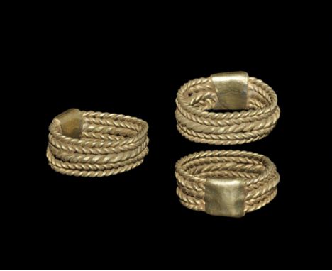 6th-10th century AD. A gold hoop formed from five alternating parallel twisted rods in herringbone pattern, flat-section conn