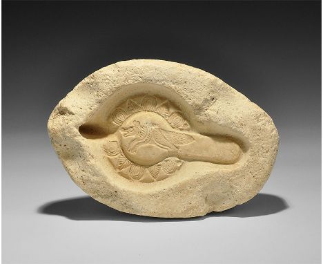 5th-7th century AD. A buff coloured ceramic mould for an oil lamp showing a running fox with round and triangular leaf patter