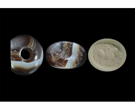 3rd-7th century AD. A carved banded agate seal matrix with intaglio design of a winged horse with Pahlavi text above; supplie