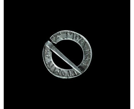 14th century AD. A flat-section silver annular brooch with triangular tongue; to the plaque the blundered legend 'AMOLVNICITO