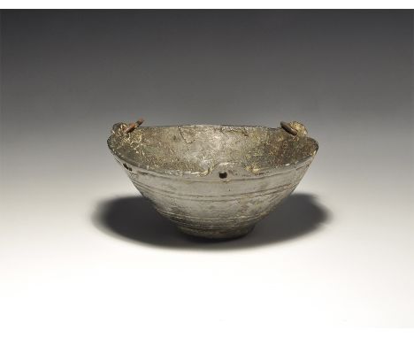 12th-13th century AD. A hemispherical bowl with circumferential banding to the exterior face, raised rib, three D-shaped rein