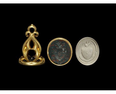20th century AD. A gold-mounted fob seal with pierced frame and oval green/red bloodstone face depicting intaglio heater shie