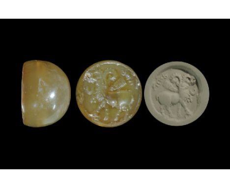3rd-7th century AD. A carved agate seal matrix with intaglio design of a ram with decorative collar, text and symbols around;