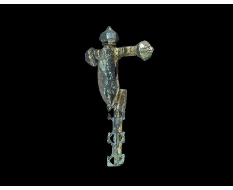 5th century AD. A fabricated crossbow brooch with facetted onion-shaped knops to the arms and a third above the bow; the arms