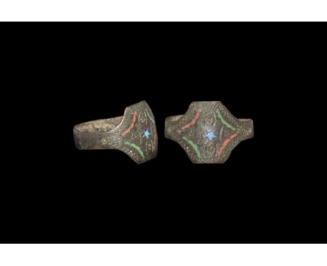 12th-15th century AD. A flat-section hoop with transverse rectangular plaque, punched floral and linear motifs, central star 