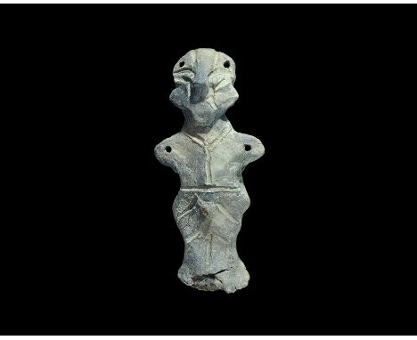 Neolithic, 6th-5th millennium BC. A terracotta robed figure with stub arms, pinched facial features, exposed male genitals, i