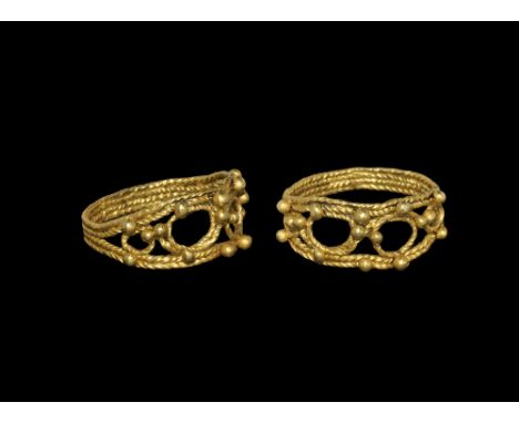6th-9th century AD. A broad hoop formed from four twisted filigree bands, expanding shoulders, plaque with granules and filig