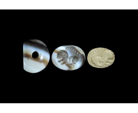 3rd-7th century AD. A carved agate seal matrix with intaglio design of a lion advancing with text above; supplied with a muse