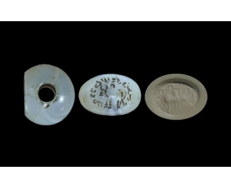 3rd-7th century AD. A carved agate seal matrix with intaglio design of a zebu with Pahlavi text and symbols around; supplied 