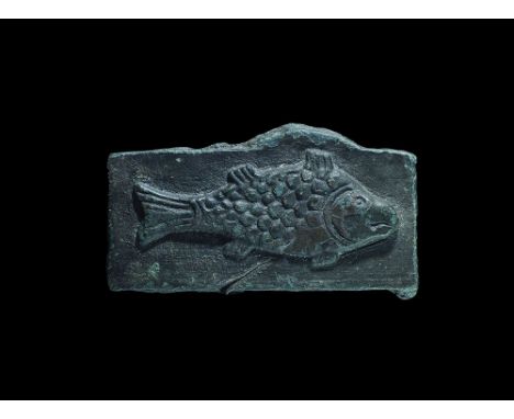 12th-14th century AD. A bronze rectangular patrix die with high-relief image of a fish with scale detail. 48 grams, 60mm (2 1