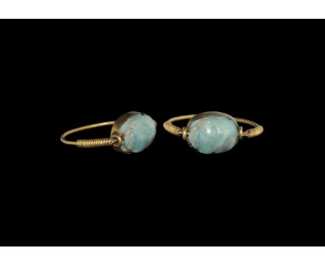 19th century AD. A carved amazonite feldspar scarab with plain underside mounted in a gold finger ring with swivel bezel, coi