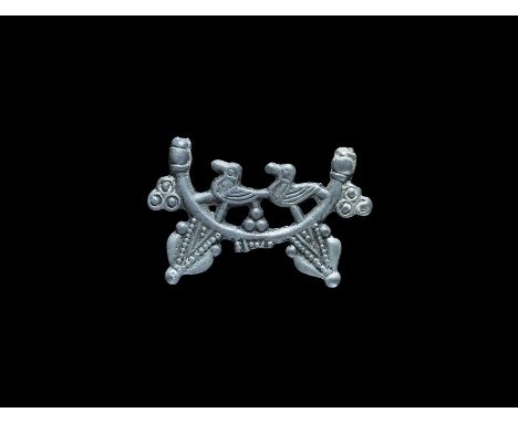 11th-13th century AD. An arc with collars to the finial, a pair of birds (probably ravens), bosses and radiating triangular p